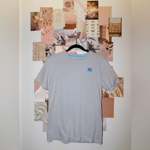 This is a light gray women’s T-shirt with a little blue camera and is a M
